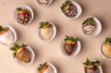 New Year's chocolate-covered strawberries laid out on a backdrop.
