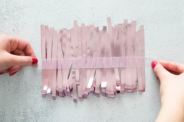 Clear tape on pink tinsel fringe