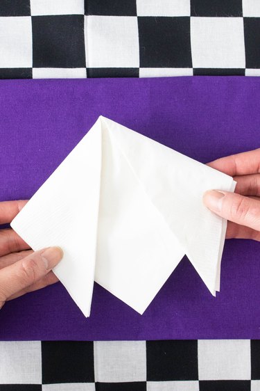 Fold the napkin into a collar shape