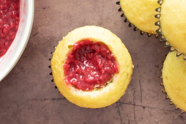 Vanilla cupcakes filled with raspberry sauce