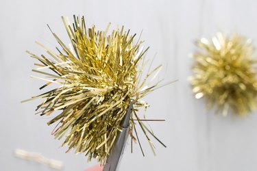 Tinsel pom pom with a gold jump ring