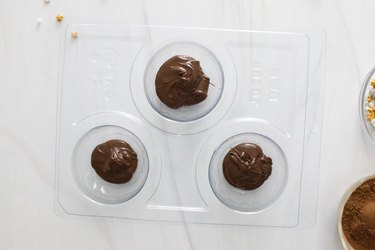 Melted chocolate in sphere molds