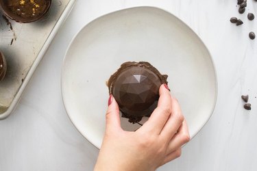 Dip chocolate half sphere into melted chocolate