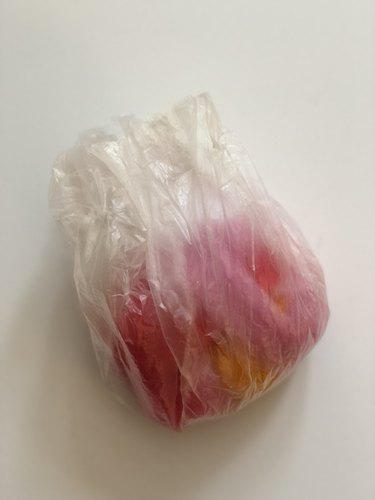 Soap wrapped in wool roving in a plastic bag