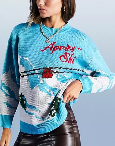 A light blue sweater with a ski lift scene and the words "apres-ski" in red lettering.