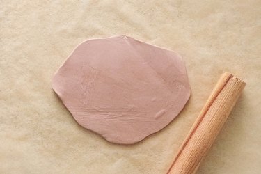 Roll brown clay into oval shape