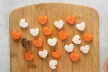 Carrot and radish hearts on a cutting board