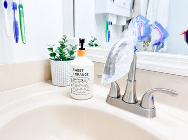 use a baggie of vinegar to clean bathroom faucets