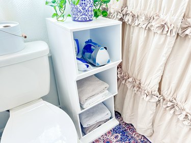 small shelf with towels and iron/steamer