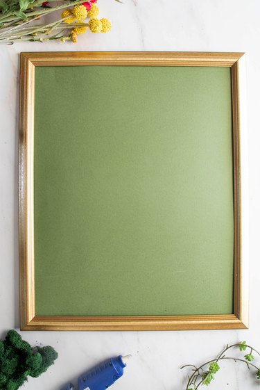 Gold frame with green paper