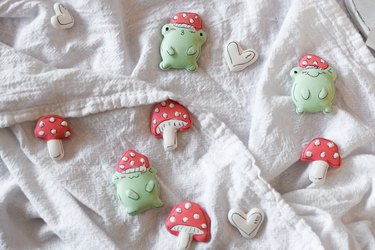 Frog and mushroom meringue cookies on linen cloth