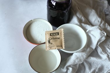 Packet of gelatin, ube extract and bowls of water and sugar