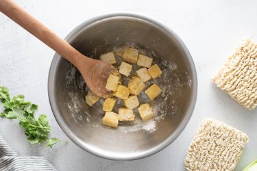 Preparing crispy tofu in a bowl
