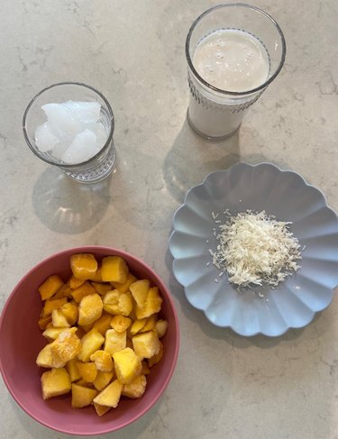 Mango, coconut milk, ice and coconut for smoothies