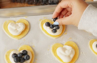 Adding blueberries to cream cheese danish