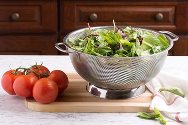 stainless steel colander with lettuce in it