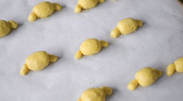 Lined baking tray with Pompompurin cookie heads.