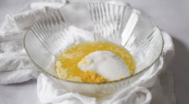 Large mixing bowl with melted butter, sugar and lemon zest.