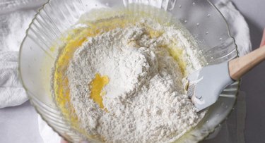 Mixing bowl with dry ingredients on top of wet ingredients.