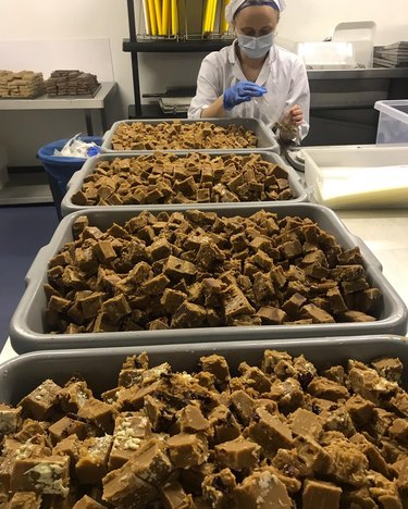 Woman packaging fudge squares in plastic bag