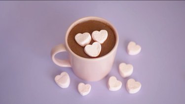 hot chocolate in a pink cup with pink heart marshmallows