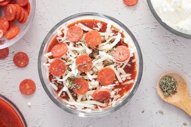 Top with pizza sauce, shredded mozzarella, mini pepperoni and Italian seasoning
