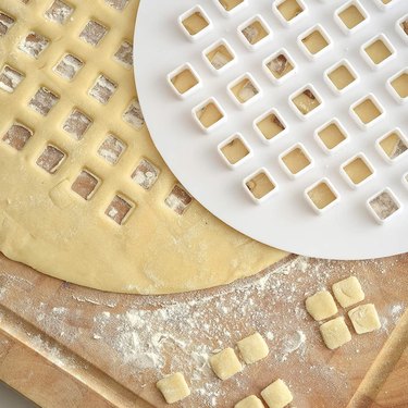 White pie lattice cutter atop pie dough