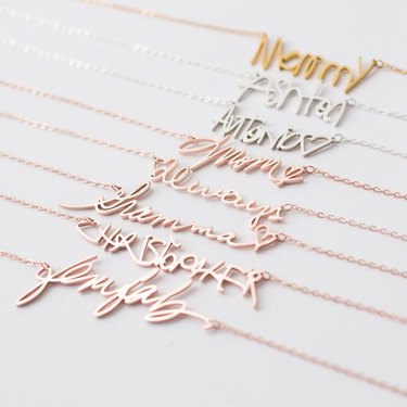 Assorted necklaces in rose gold, gold, and sterling silver featuring cursive and handwritten names