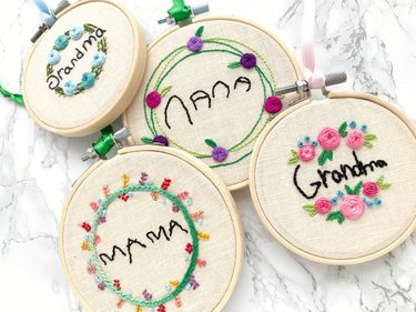 Embroidery hoops with the words "Mama," "Grandma," and "Nana" surrounded by embroidered flowers.