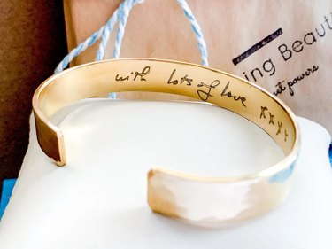 Gold bracelet engraved inside with "with lots of love xxxx"