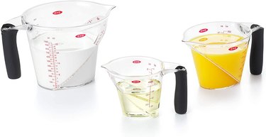 Set of three OXO measuring cups against a white background
