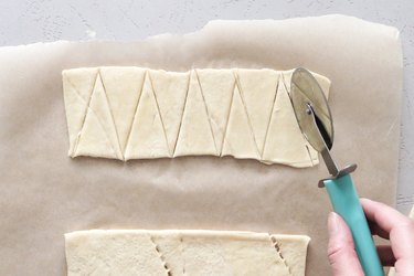 Slicing crescent dough into triangles