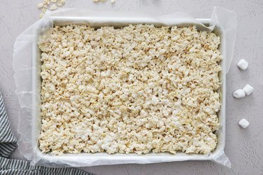 Marshmallow treat mixture in a baking sheet