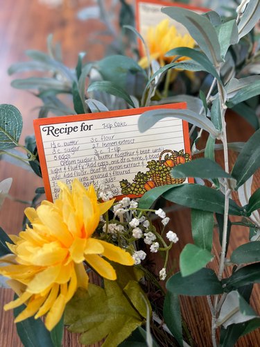 recipe card and faux flowers stuck into wreath form