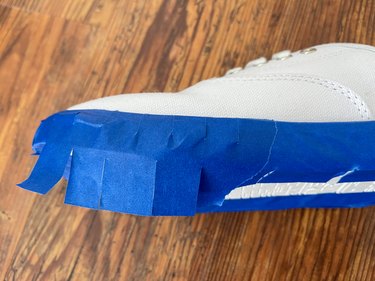 clip painter's tape to help it go around round edges of shoes