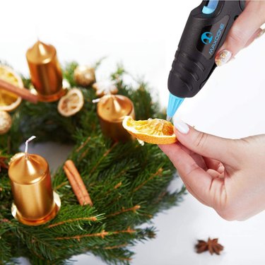 Maxdone Mini Hot Glue Gun Being Used on a Holiday Wreath