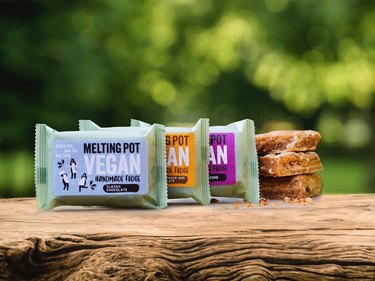 Vegan fudge packaged alongside stack of unwrapped fudge