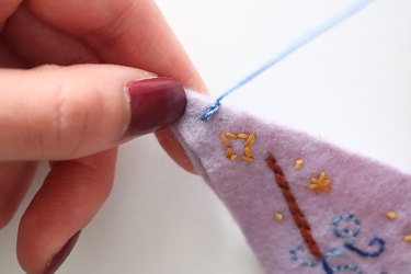 Pull the thread to create the first blanket stitch