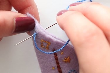 Insert embroidery thread from the back to front to make a blanket stitch