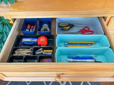 use plastic containers to organize junk drawers
