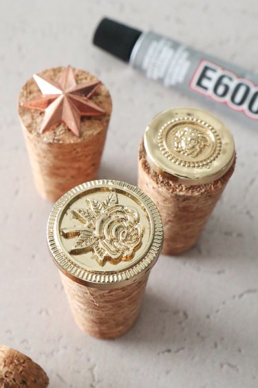 Gluing buttons on top of corks to make wax seal stamps