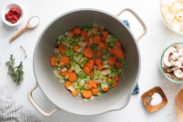 Onion, celery, and carrots in a pot