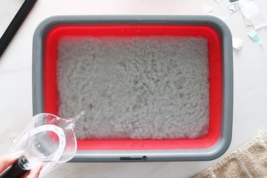 Paper pulp and water in a plastic bin
