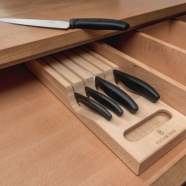 Victorinox knives and wooden in-drawer tray, displayed in drawer with chef knife on the countertop above