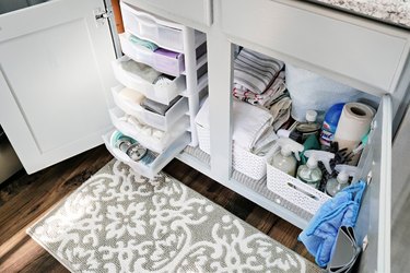 stackable storage bins under a kitchen sink