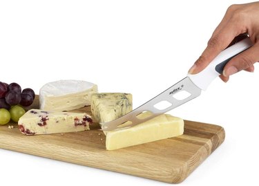 Zyliss Comfort Cheese Knife Cutting Into Cheese on a Serving Tray