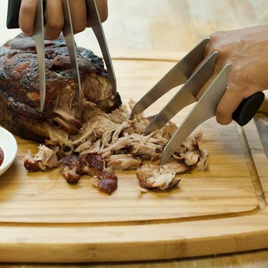 Charcoal Companion Slash & Serve BBQ Meat Pulled Pork Shredder Claws / Set of Two Barbecue Tools Being Used to Shred Meat on a Cutting Board