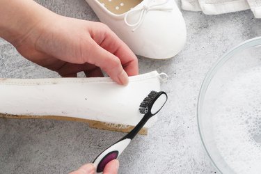 Scrub shoes with soapy water