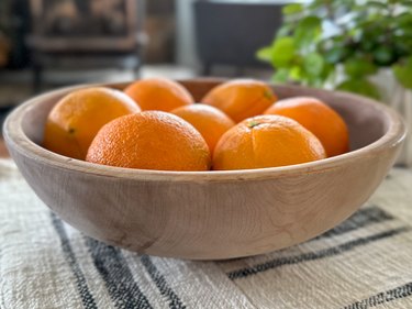 finished bleached wooden bowl filled with oranges