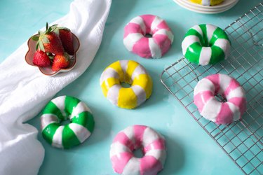 Pool tube donuts on a wire rack and blue backdrop